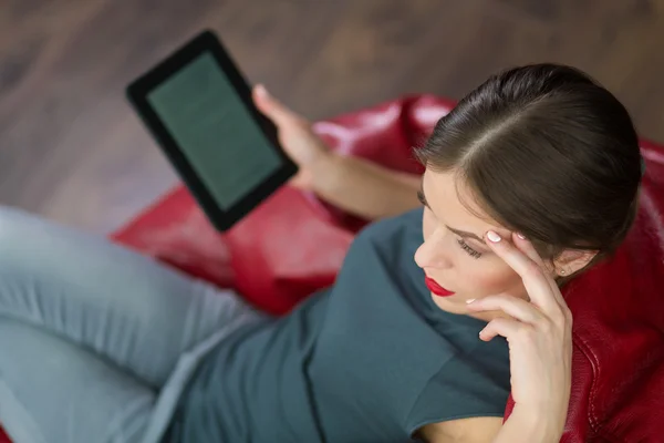 Mulher lendo um ebook em sua casa — Fotografia de Stock