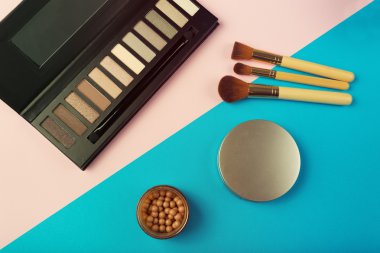 Makeup essentials on a pink background clipart