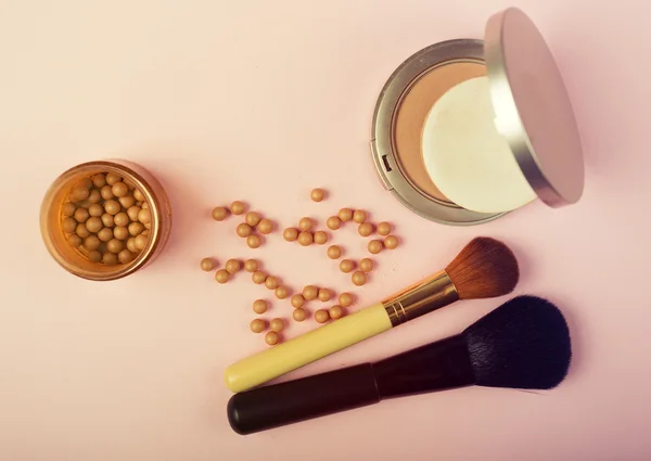 Makeup essentials on a pink background — Stock Photo, Image