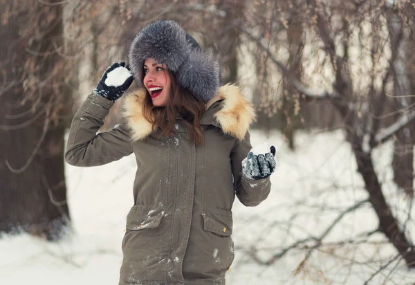 Beautiful woman playing snowballs — Stock Photo, Image