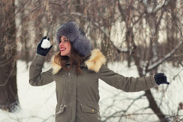 Beautiful woman playing snowballs — Stock Photo, Image