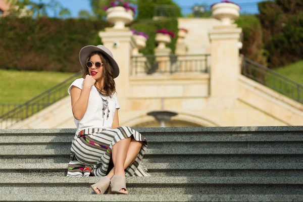 Beautiful boho girl sitting on the stairs — Stock Photo, Image