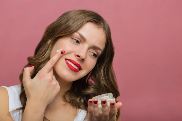 Beautiful woman with a face moisturizer — Stock Photo, Image