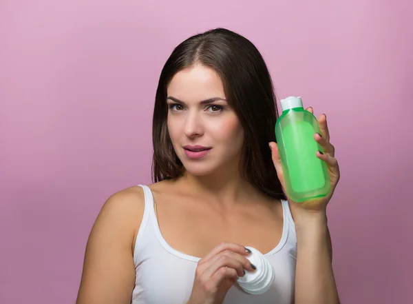 Mulher bonita com um produto de cuidados da pele — Fotografia de Stock