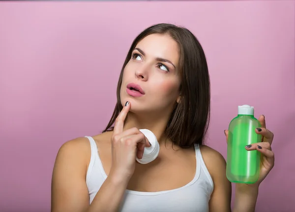 Pretty woman with a skin care product — Stock Photo, Image