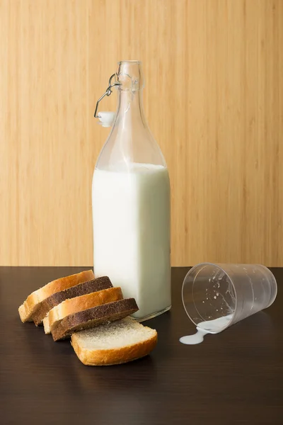 Milk bottle and bread — Stock Photo, Image