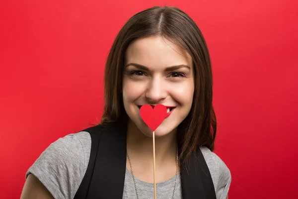 Beautiful woman with red heart — Stock Photo, Image