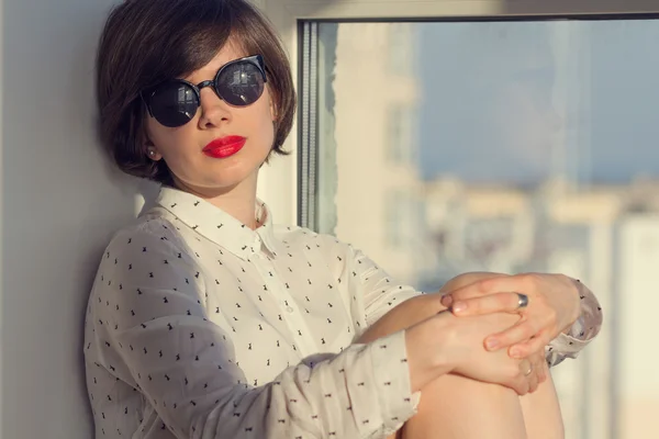 Dreamy girl near the window — Stock Photo, Image