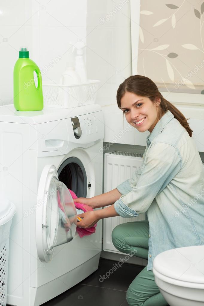 Beautiful girl doing laundry Stock Photo by ©Tinatin1 73950985