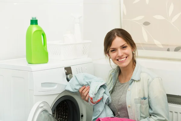 Beautiful girl doing laundry — Stock Photo, Image