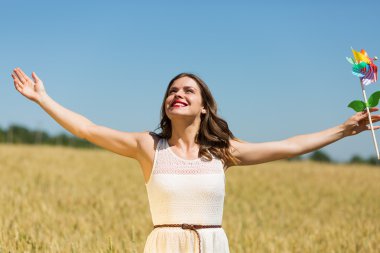 Happy girl with a colorful windmill 