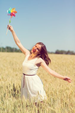 Happy girl with a colorful windmill 