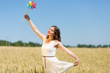 Happy girl with a colorful windmill 