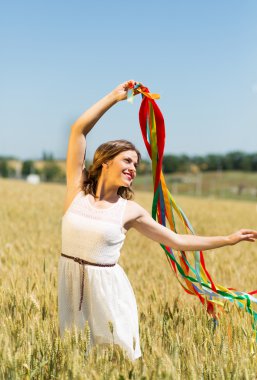Happy girl holding colorful ribbons 
