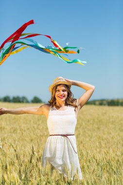 Happy girl holding colorful ribbons 
