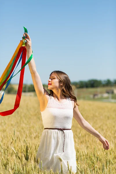 Happy girl holding colorful ribbons — ストック写真