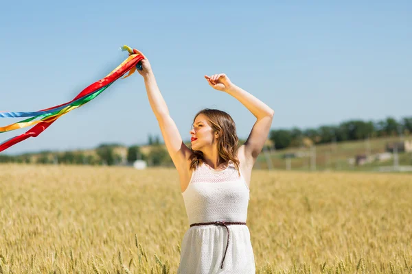 Happy girl holding colorful ribbons — ストック写真