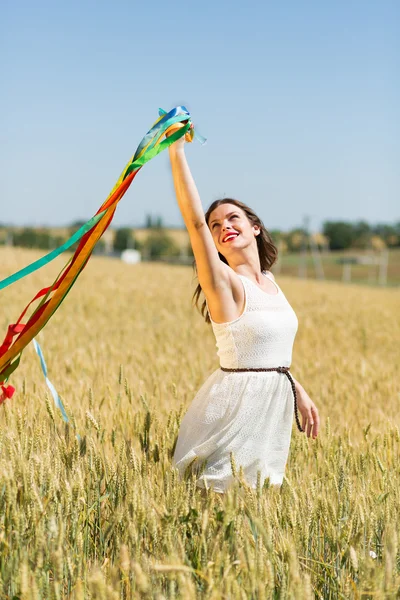 Happy girl holding colorful ribbons — ストック写真