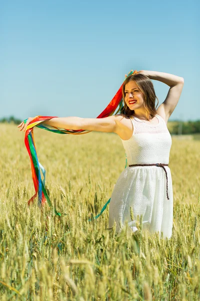 Happy girl holding colorful ribbons — Stok fotoğraf