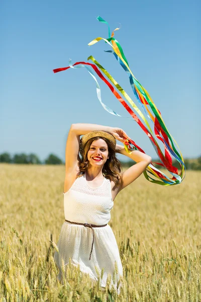 Happy girl holding colorful ribbons — ストック写真