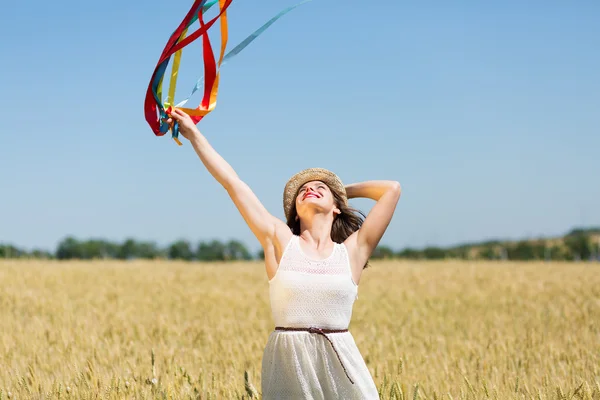 Happy girl holding colorful ribbons — ストック写真