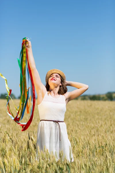 Happy girl holding colorful ribbons — ストック写真