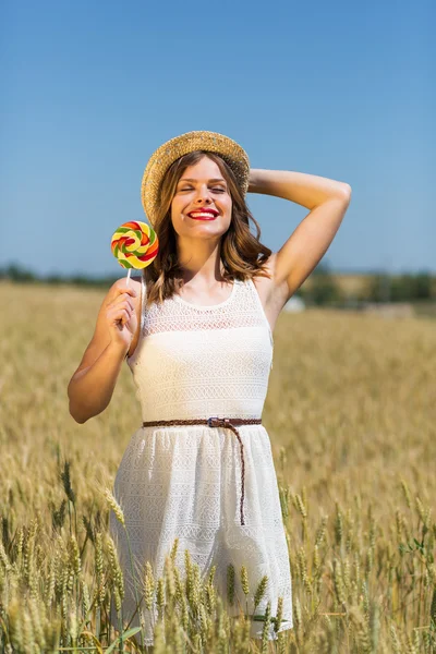 Happy girl with a candy — Stock Photo, Image