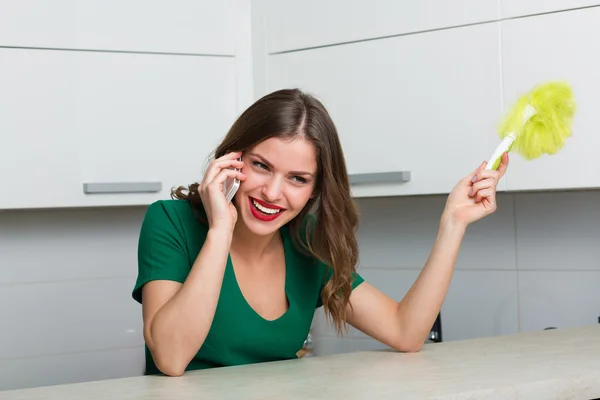 Mulher espanando e limpando sua casa — Fotografia de Stock