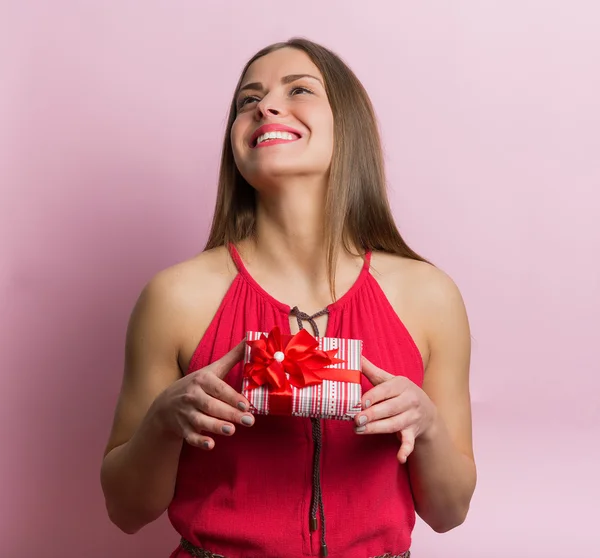 Woman in red dress with a gift box — Stock Photo, Image