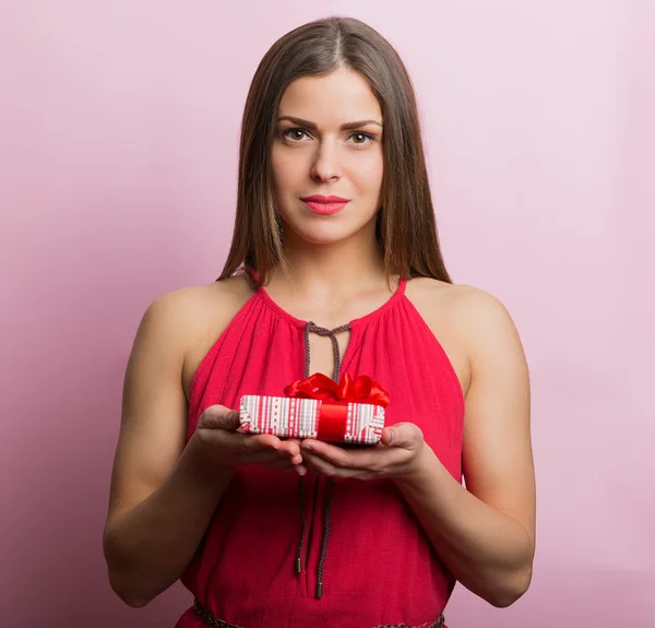 Woman in red dress with a gift box — Stock Photo, Image