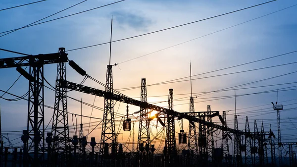 distribution electric substation with power lines and transformers, at sunset. horizontal frame. electrical distribution stations. distribution electric substation with power lines and transformers,