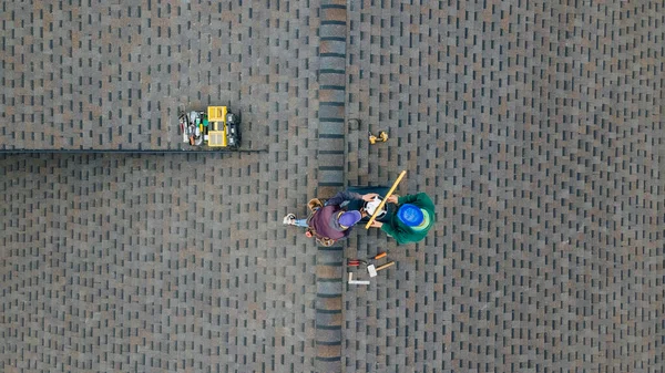 Aerial view of a two workers on the roof installing the iron chimney. — Stock Photo, Image