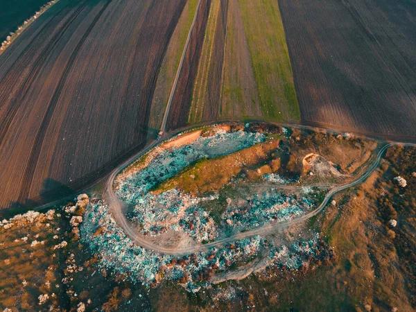 aerial view of the garbage truck near the agricultural lands.