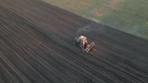 Aerial shot of Agricultural industry tractors machinery tools plow large areas soil — Stock Video