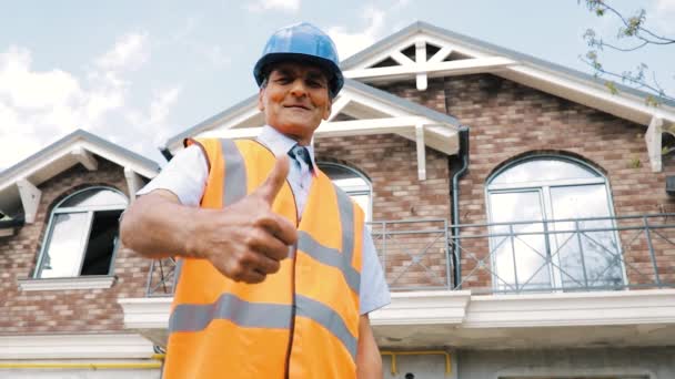 Joyeux constructeur indien masculin senior faisant comme geste en utilisant les pouces vers le haut portant le travail — Video