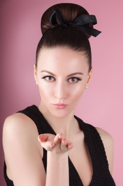 Portrait of young beautiful fresh slim girl with clean make-up and hair bun