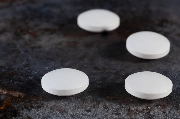 Four White Pills Close Stone Background — Stock Photo, Image