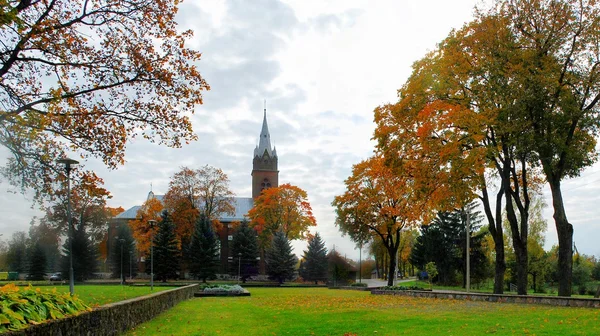 Church in little town at autumn time — Stock Photo, Image