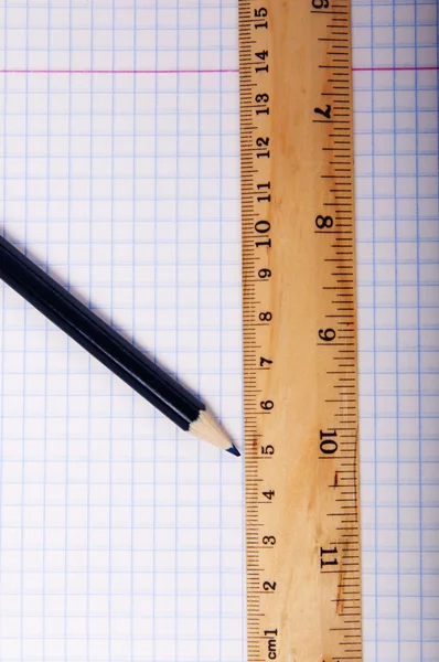 Pencil and ruler on exercise book page — Stock Photo, Image