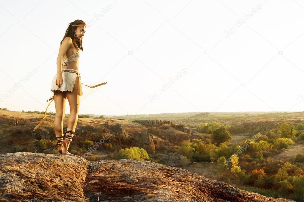 Primitive woman  holding a bow. Amazon woman