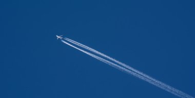 An airplane trail across the sky clipart