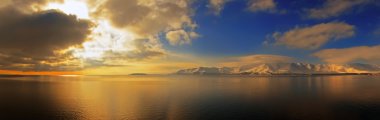 panorama of sunrise on lake Sevan, Armenia  clipart