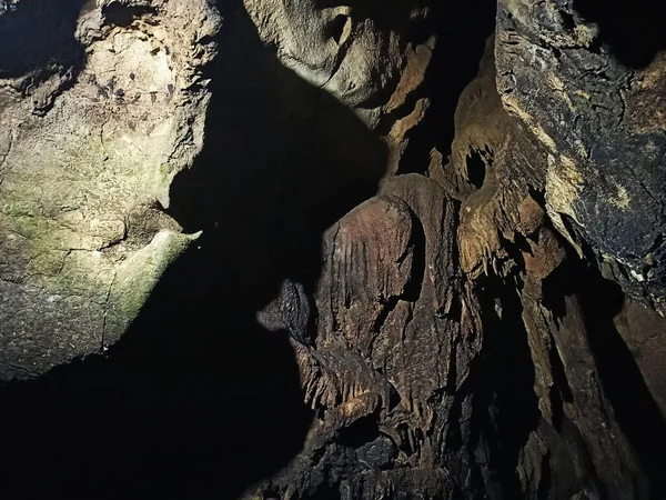 Journey. View inside a deep cave to the south. stalactites and stalagmites.