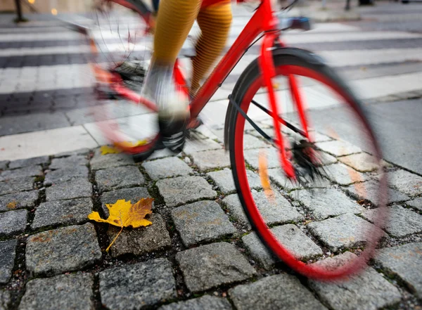 Woman on red bikein autumn — Stock Photo, Image