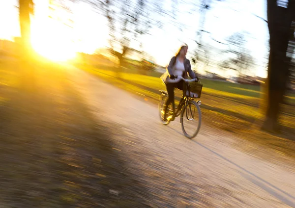 Donna in bicicletta al tramonto . — Foto Stock