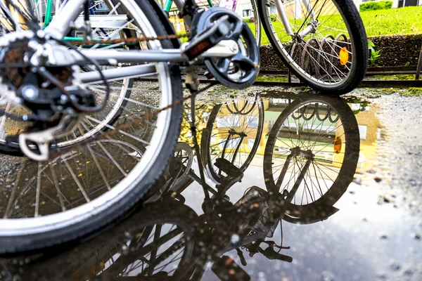 Bikes parked by bicycle rack — Stock Photo, Image