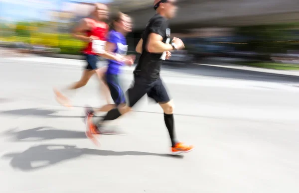 Three men in running competition — Stock Photo, Image