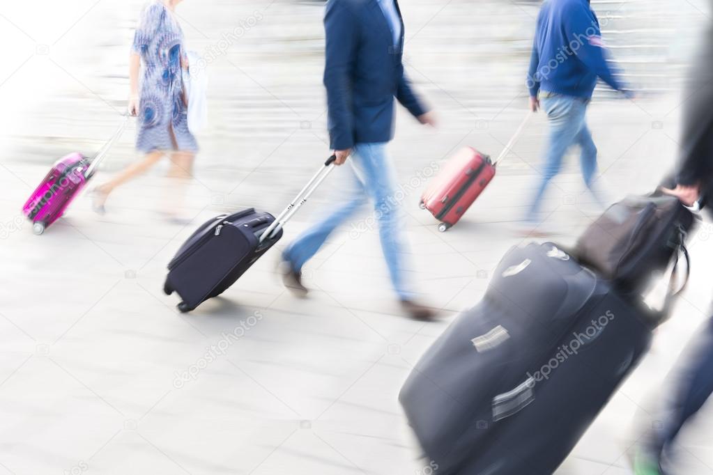 People with luggage in blurred motion