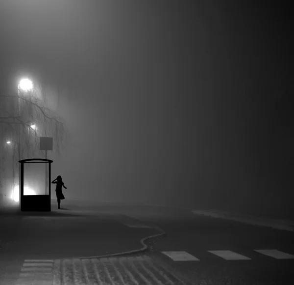 Girl at bus stop at night — Stock Photo, Image