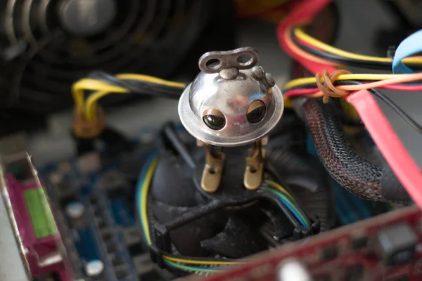 Beautiful photo of little robot repairing computer